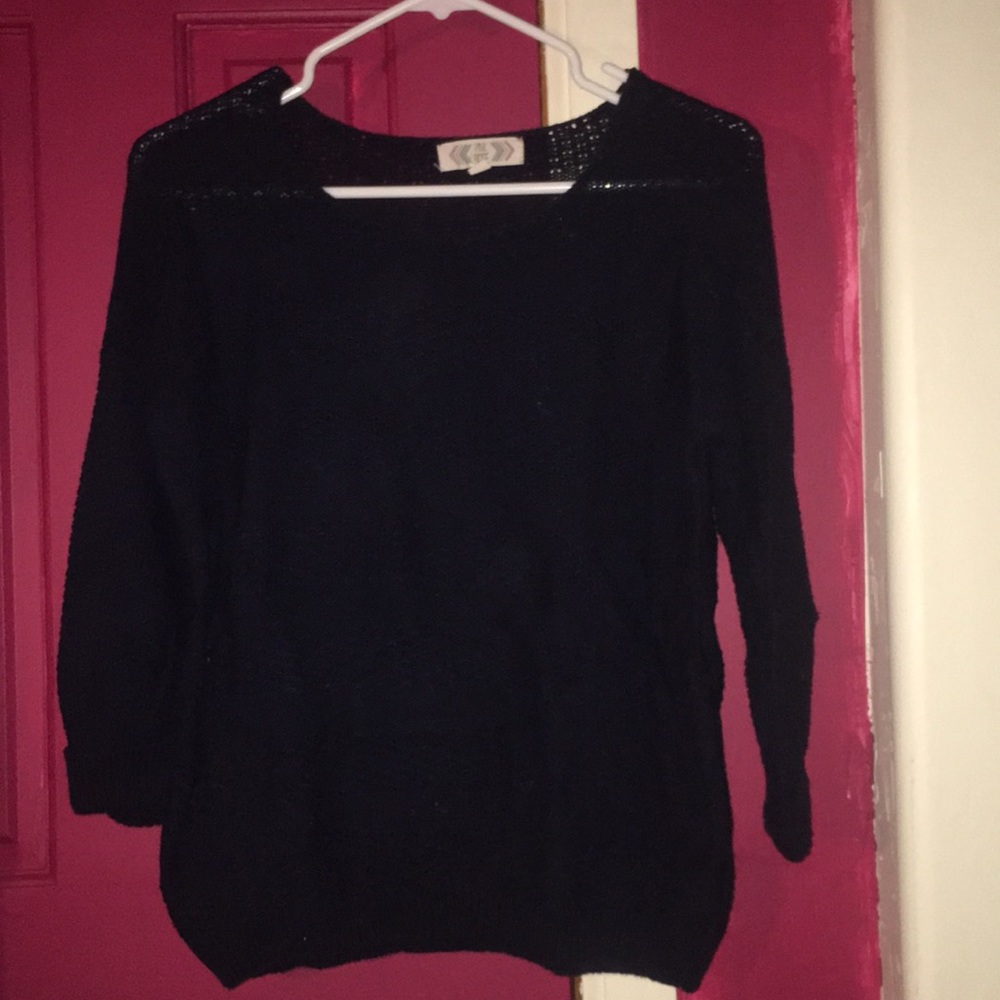 Blue knitted sweater with rolled sleeves